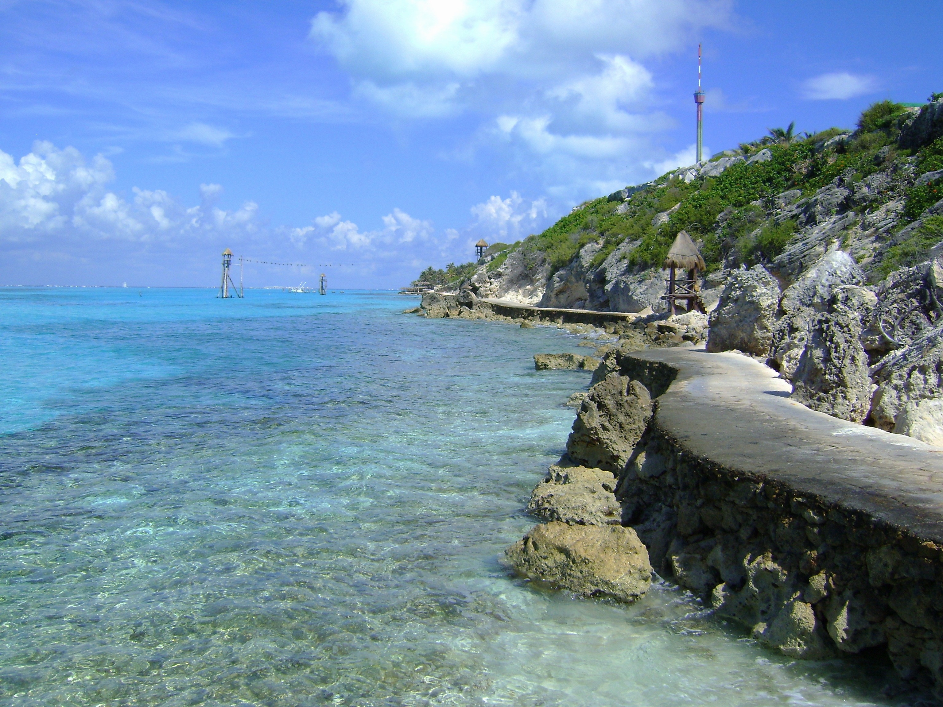 Blue water from the wide-open ocean meeting up with the rocky limestone cliffs of Cozumel.