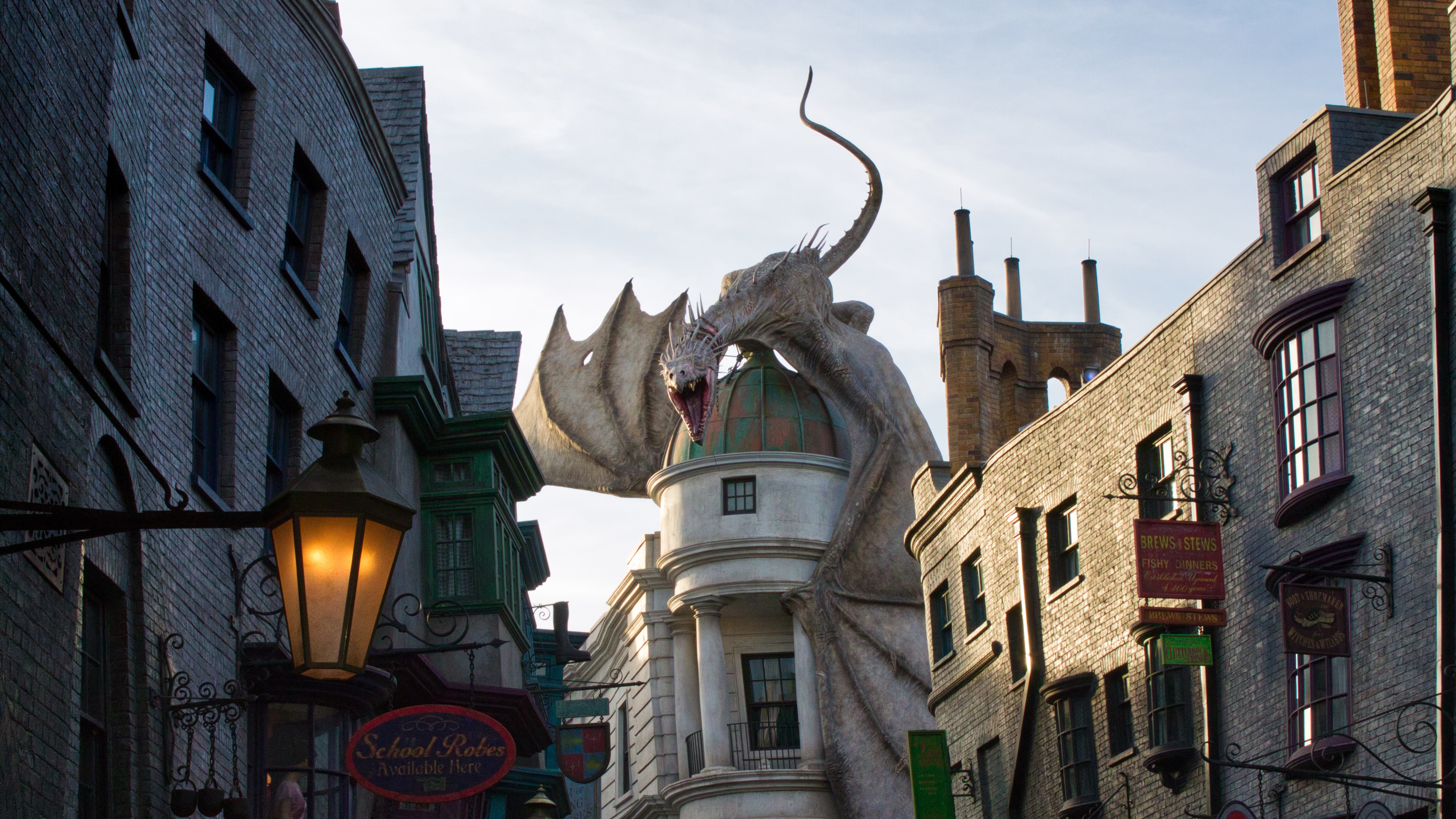 Looking down Diagon Alley at the dragon sitting on top of Gringotts Bank, ready to breathe fire.